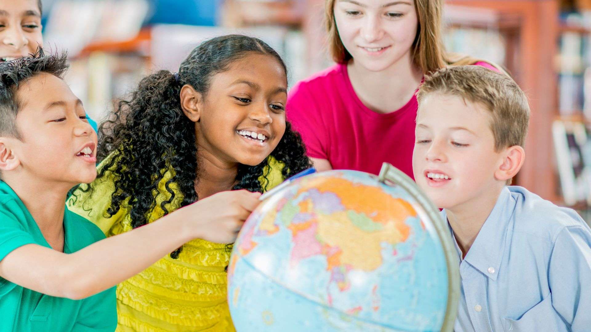 children playing with Globe in a classroom